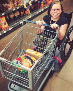 girl with CRS pushing shopping cart 